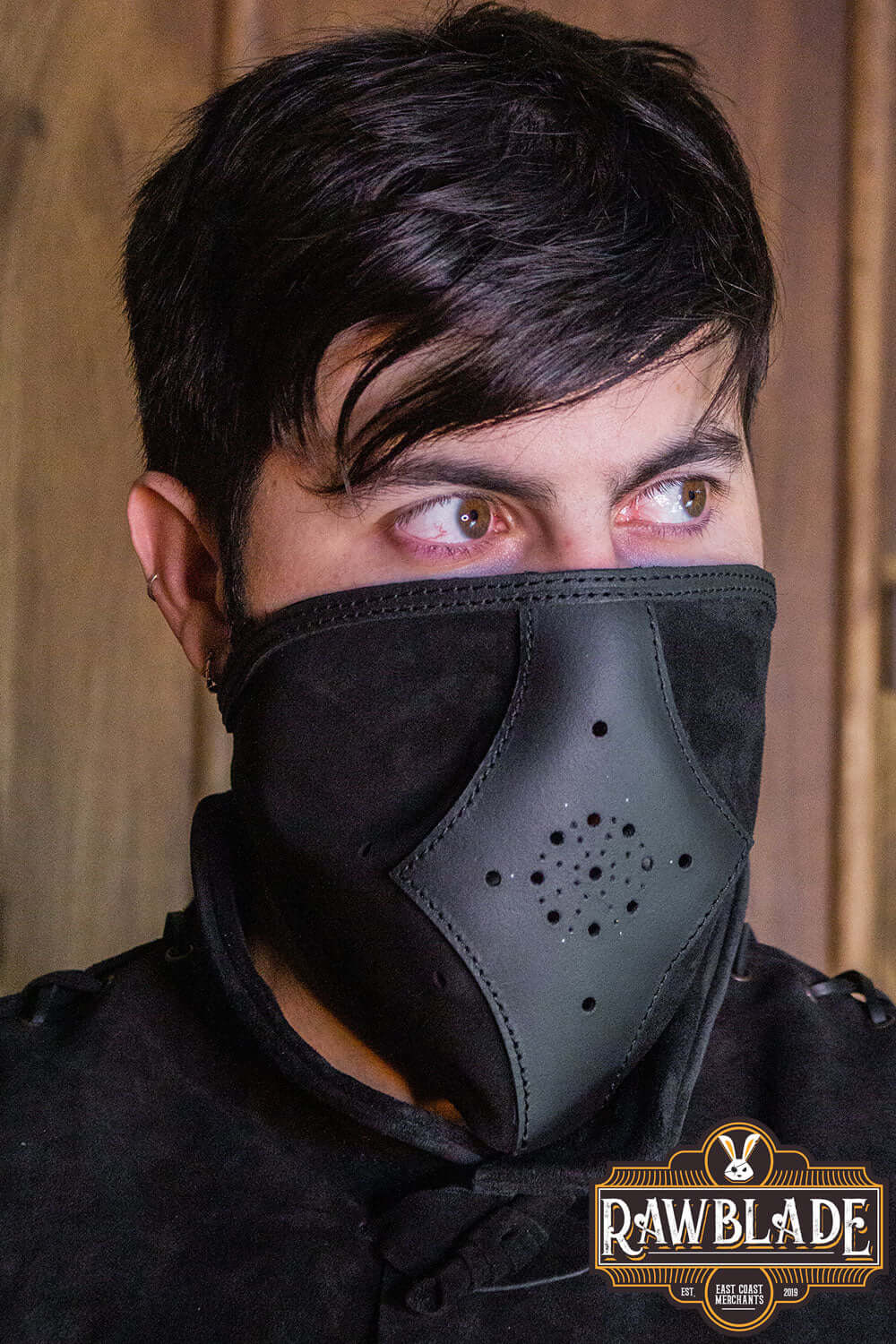 Akku Splitleather Hood worn by a man, featuring a unique design with leather reinforcements and elegant details.