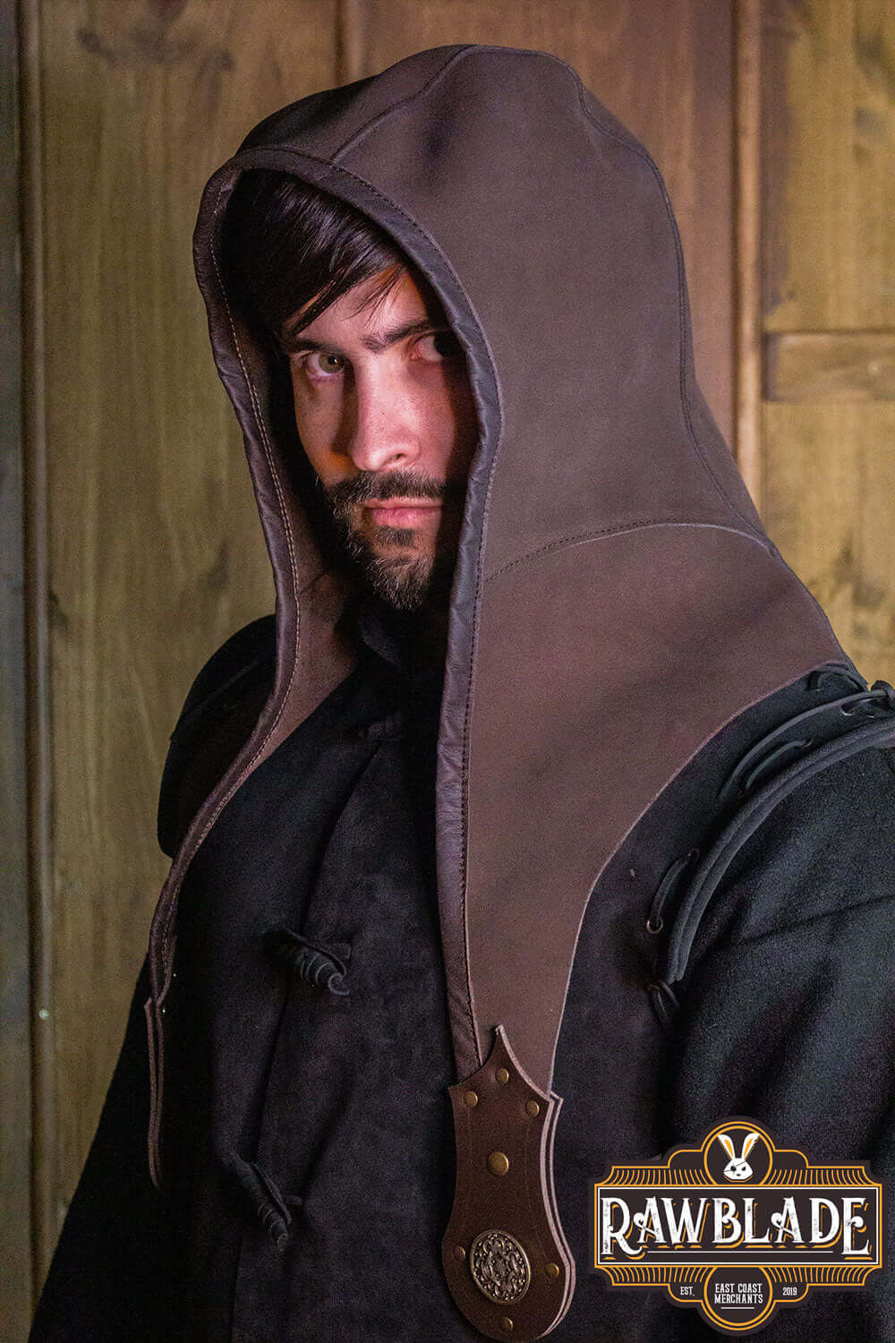 A man wearing the Akku Splitleather Hood with metal ornaments, exuding a mystical and adventurous vibe.