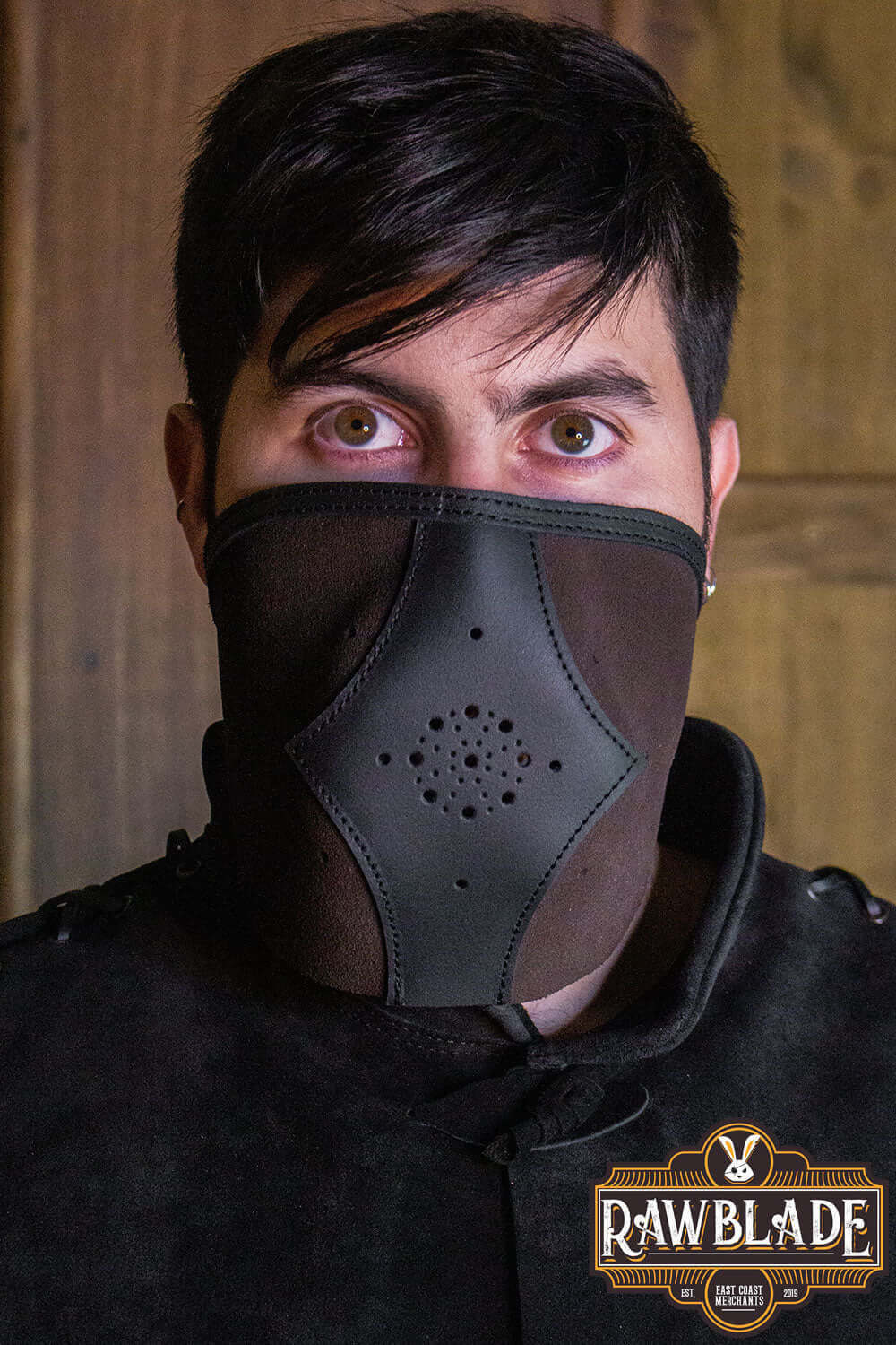 Person wearing Akku Splitleather Hood with a mask, featuring leather and metal ornaments for an elegant finish.