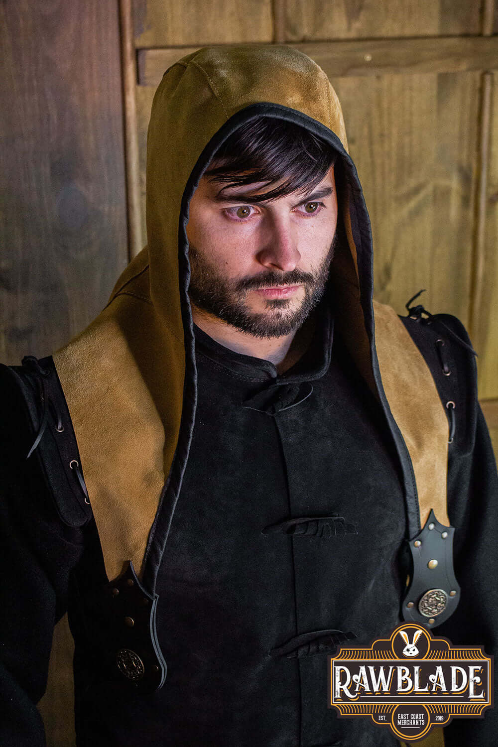 Man wearing Akku Splitleather Hood, featuring leather reinforcements and elegant design for various characters.