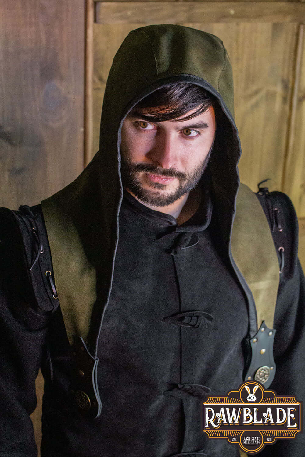Man wearing Akku Splitleather Hood with elegant design and leather reinforcements, inspired by various characters.