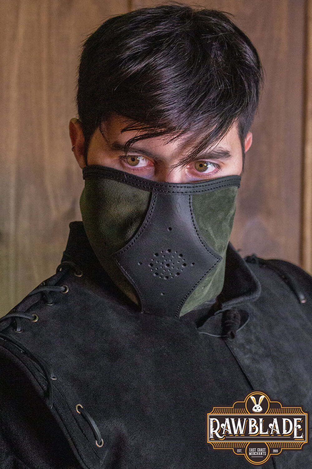 Model wearing the Akku Splitleather Hood with a mask, showcasing its unique design and leather details.