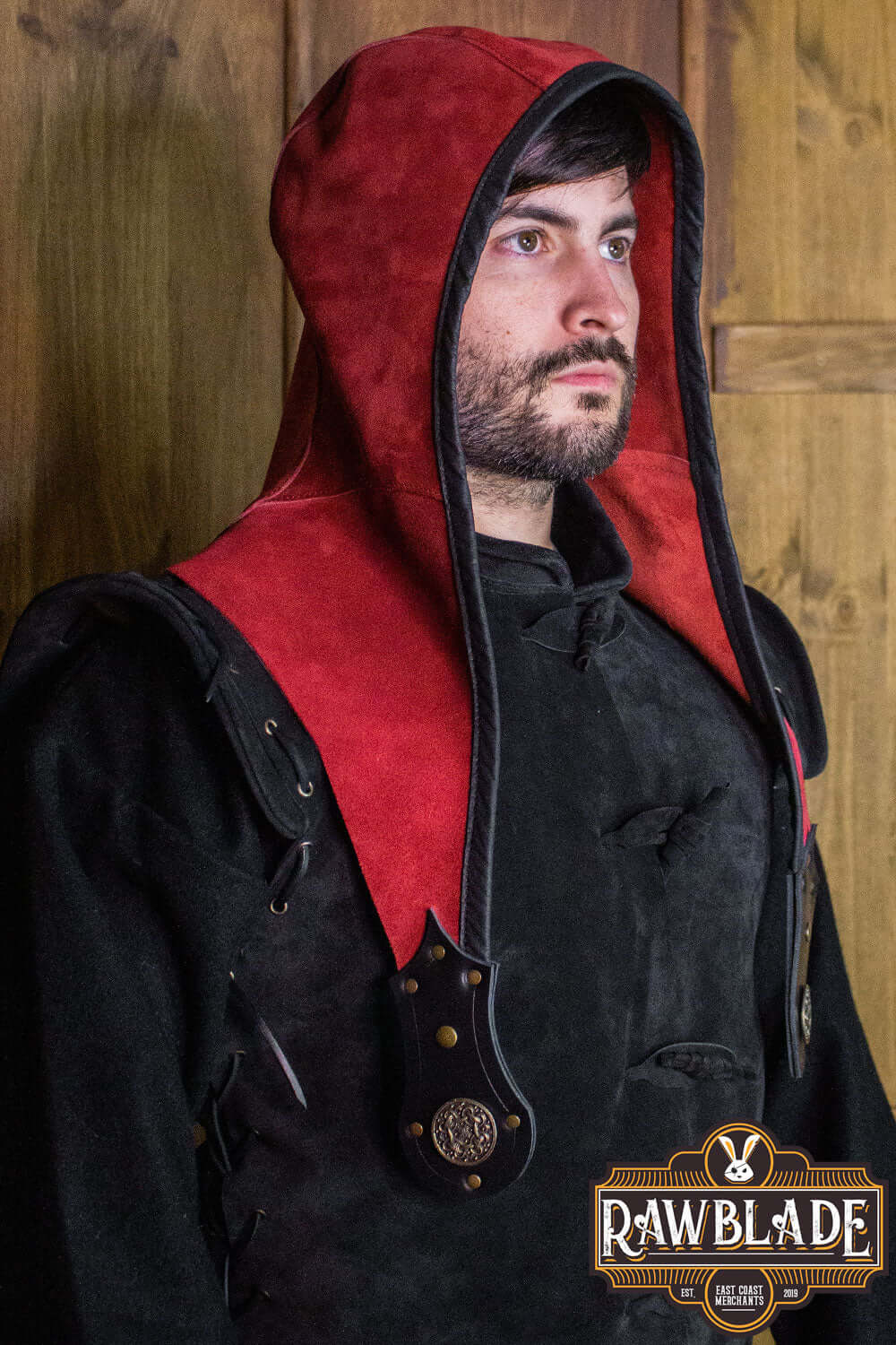 Man wearing Akku Splitleather Hood, featuring red and black leather with elegant metal ornaments.