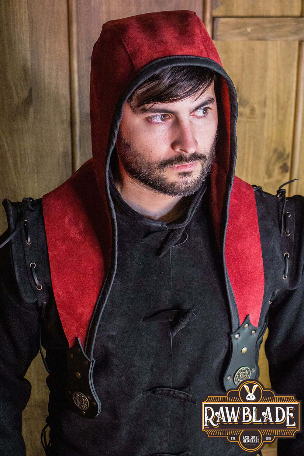Model wearing the Akku Splitleather Hood featuring red suede and black leather, showcasing unique detailing and style.