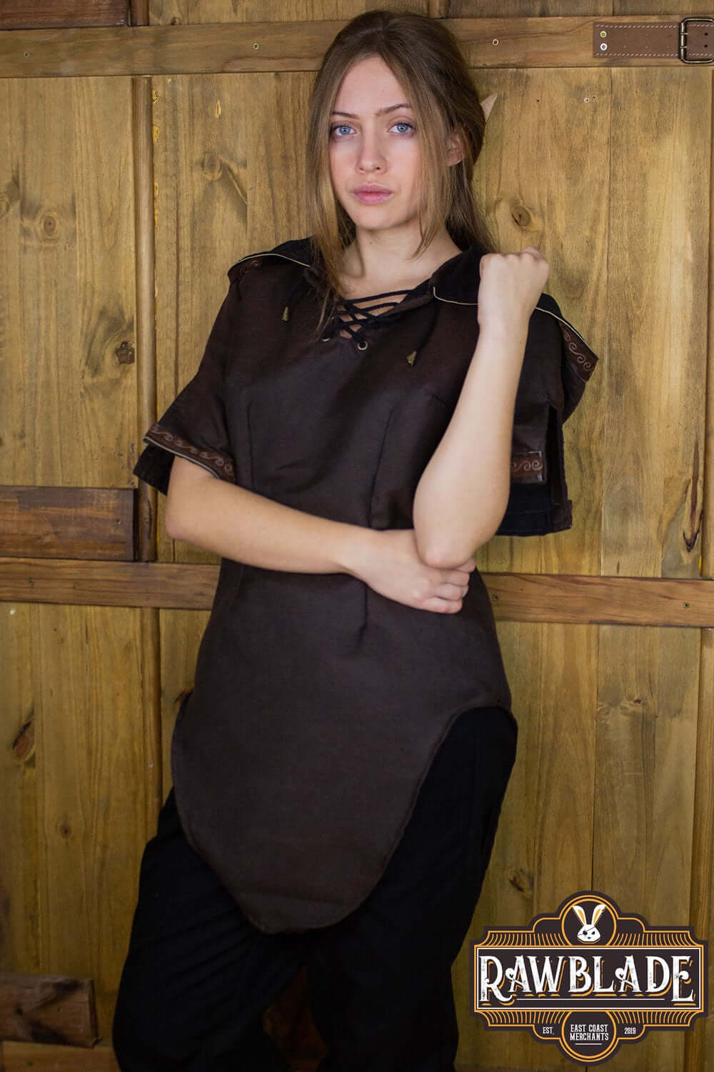 Model wearing the Briannan Ranger Tunic from Rawblade, featuring a wide hood and short leather-trimmed sleeves.