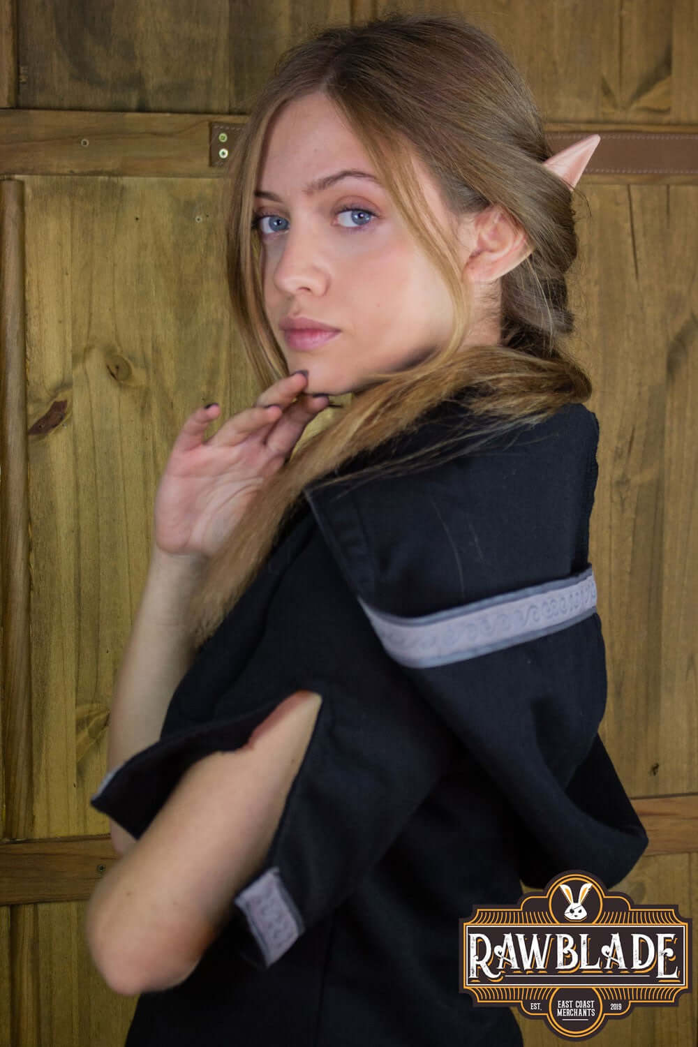 Model wearing the Briannan Ranger Tunic with a wide hood and decorated sleeves, showcasing its comfort and style.