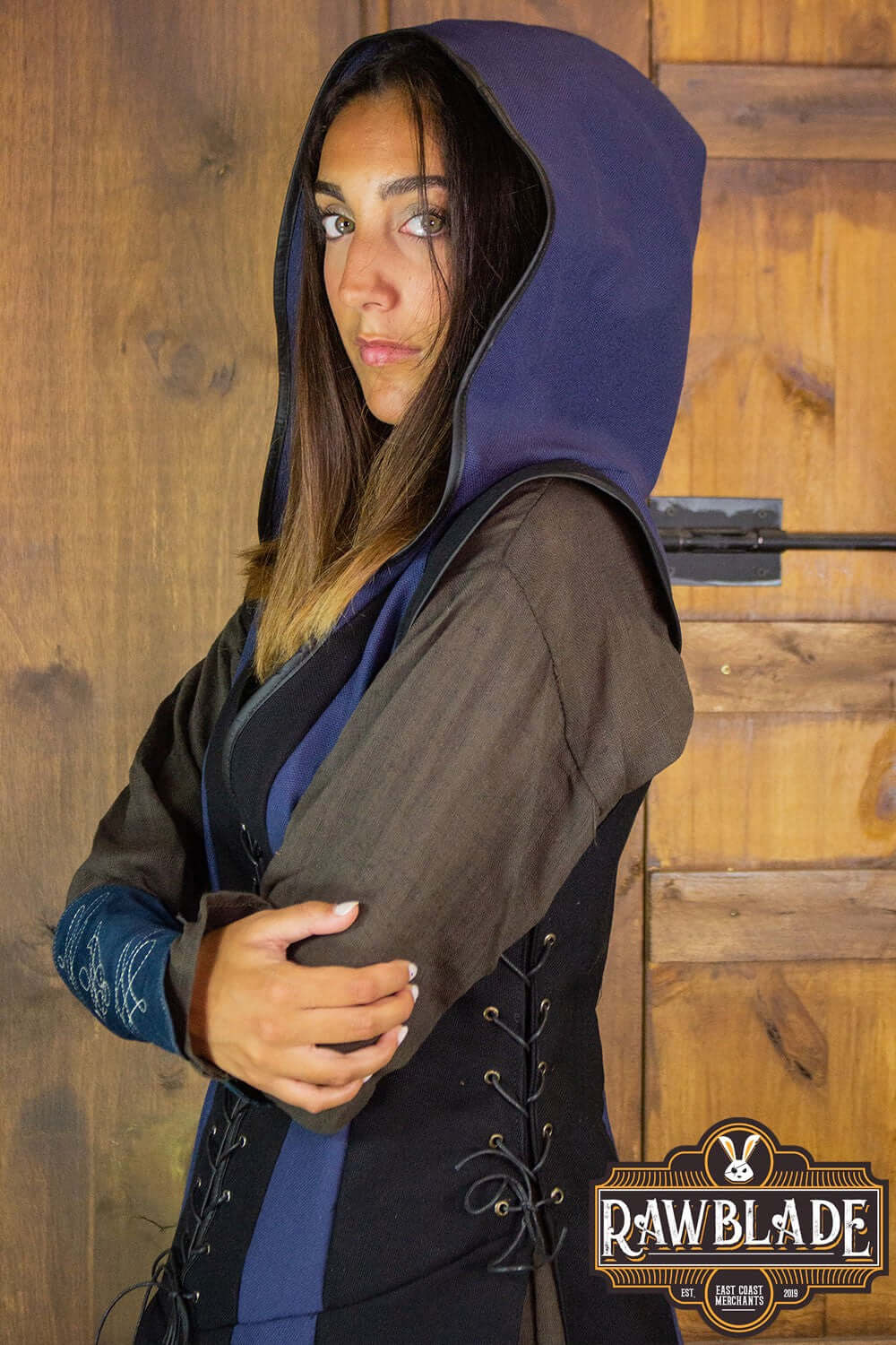 Arylith Archer Cotton Tunic displayed by a woman, featuring a wide hood and elegant design, crafted from thick-weave cotton.