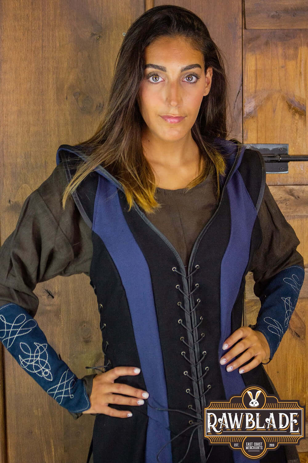 A woman modeling the Arylith Archer Cotton Tunic with adjustable drawstrings and a wide hood from Rawblade.