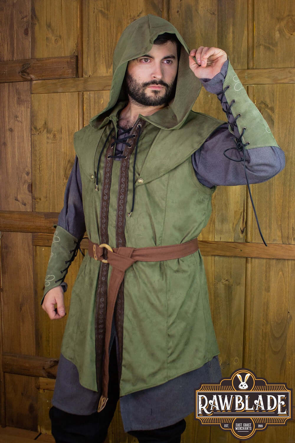 Karanthir Tunic worn by a model showcasing its wide hood and stylish design against a wooden background.