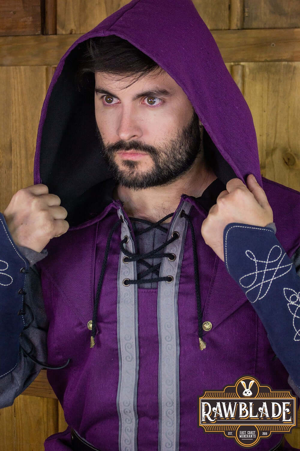 Man wearing the Karanthir Tunic by Rawblade, featuring a wide hood and stylish design for adventurers.