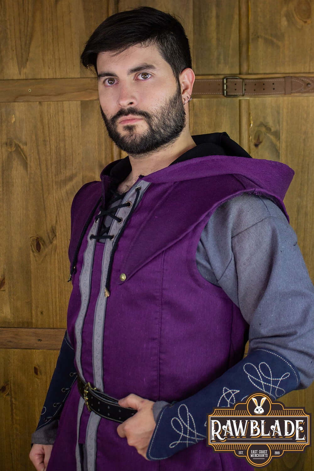 Model wearing the Karanthir Tunic from Rawblade, featuring a stylish purple hood and adventurous design.