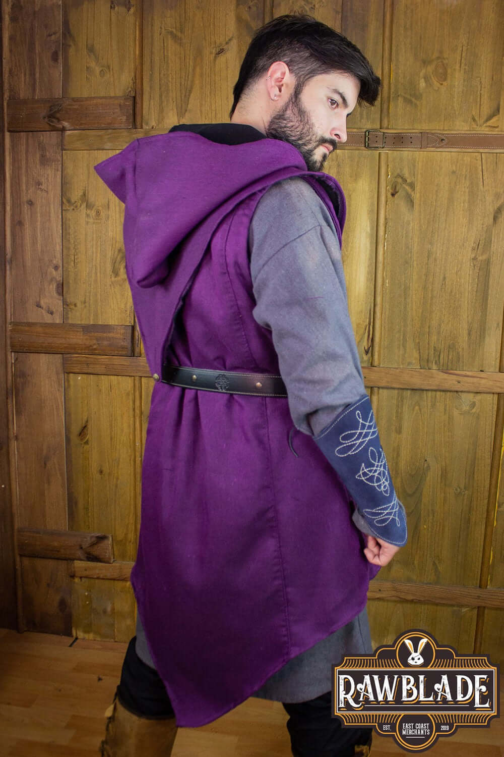 A model showcasing the Karanthir Tunic in purple with a wide hood and stylish design.