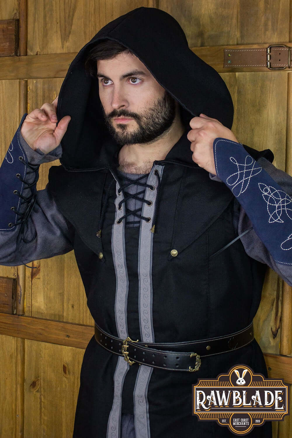 A man wearing the Karanthir Tunic from Rawblade with a wide hood and stylish design, ideal for adventures.