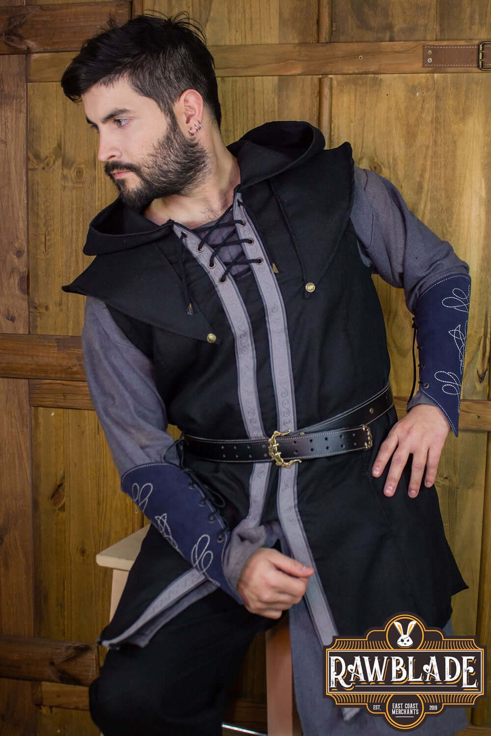 Young man wearing the Karanthir Tunic with a wide hood, styled for adventure and elegance.