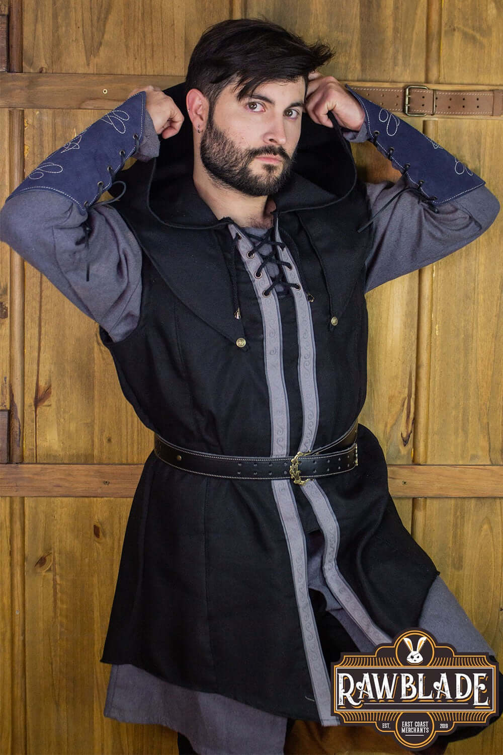 Young man wearing a Karanthir Tunic from Rawblade with a wide hood, perfect for wizards and adventures.