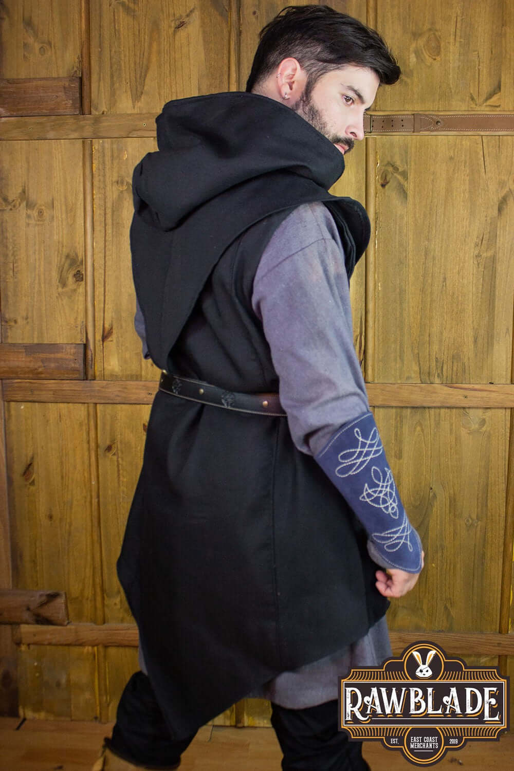Model wearing Karanthir Tunic with wide hood, perfect for young wizards or elven trackers.