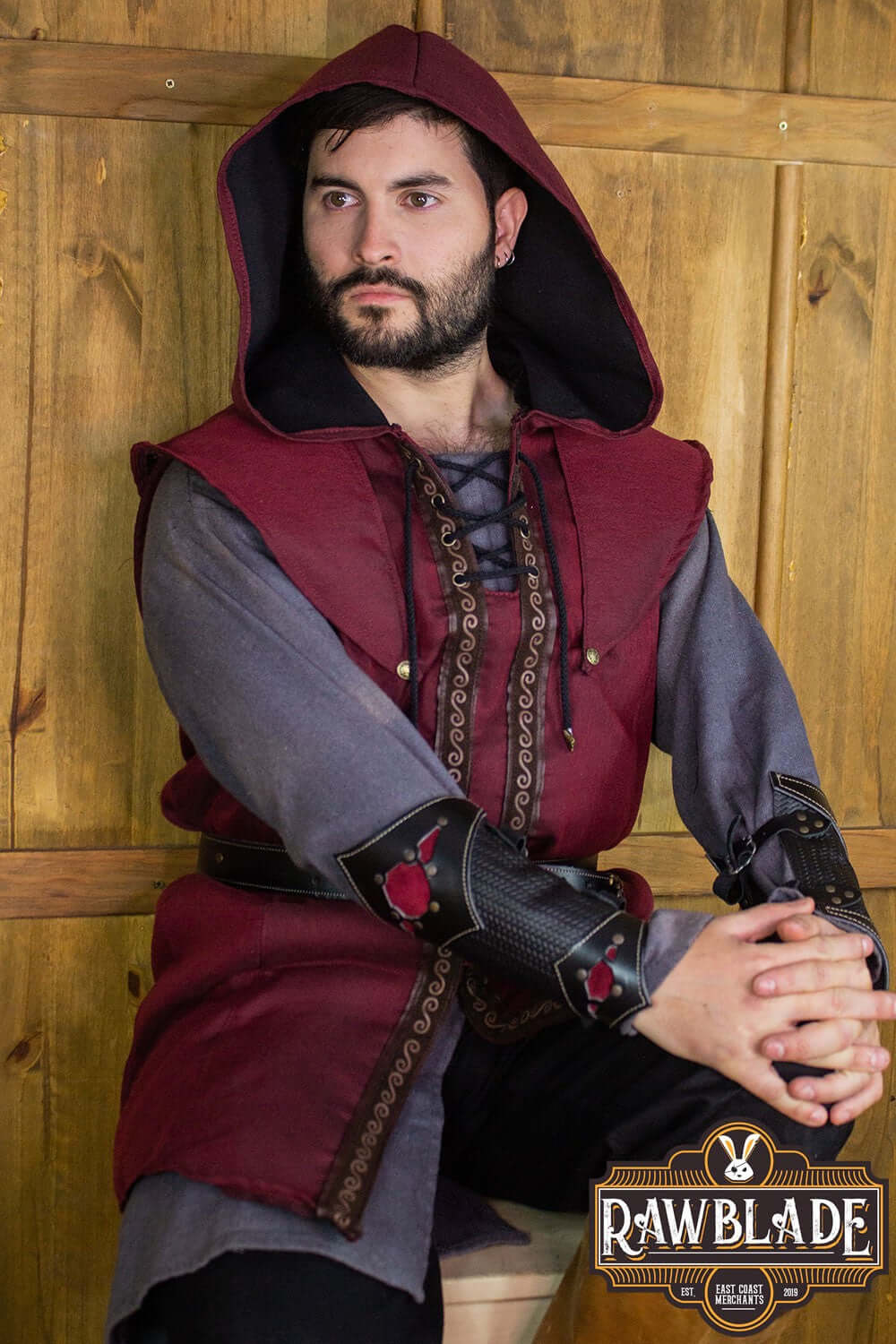 Model wearing the Karanthir Tunic by Rawblade with a wide hood, showcasing its stylish design.