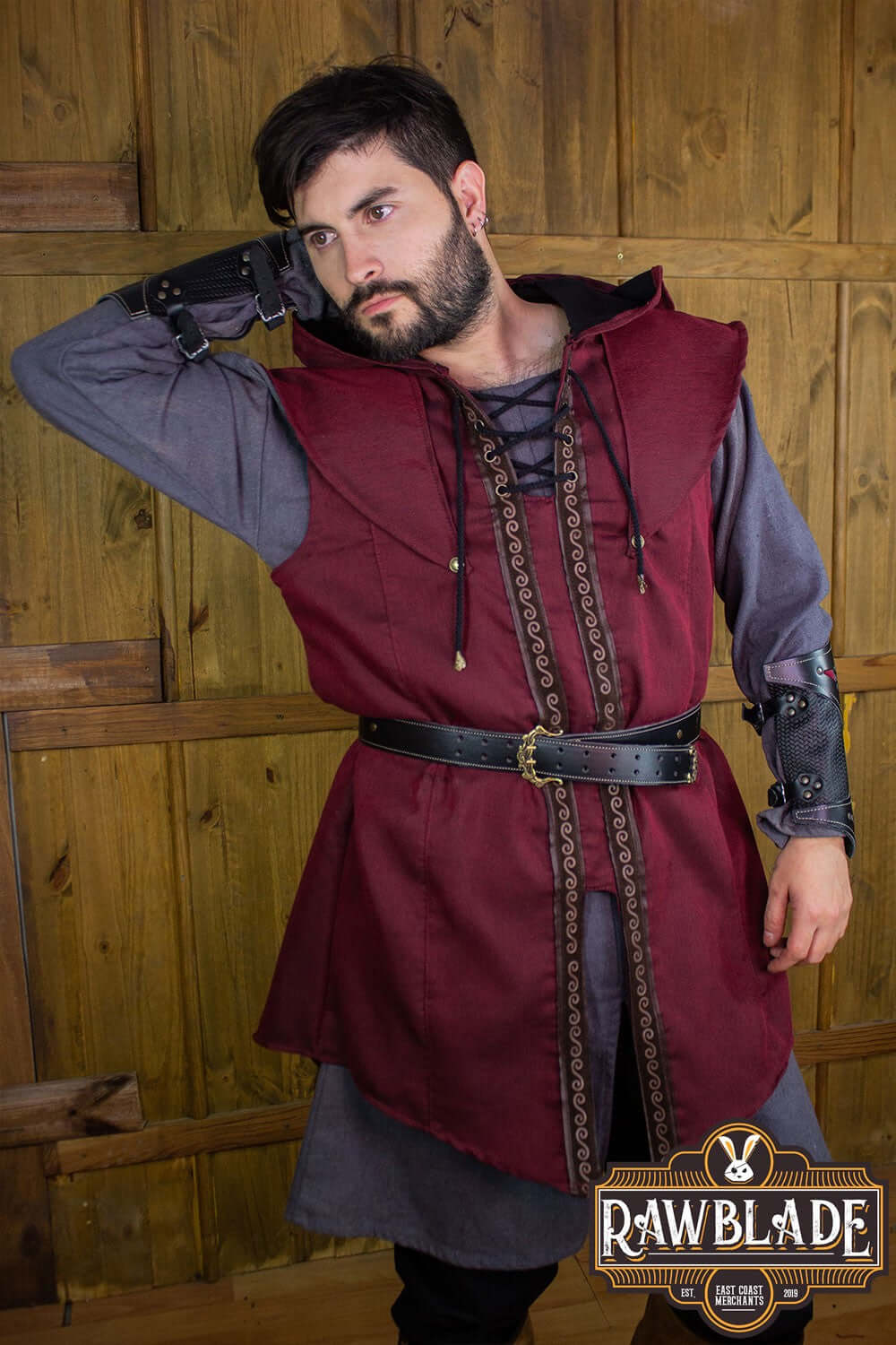 Young man wearing the Karanthir Tunic by Rawblade, featuring a wide hood and stylish design.