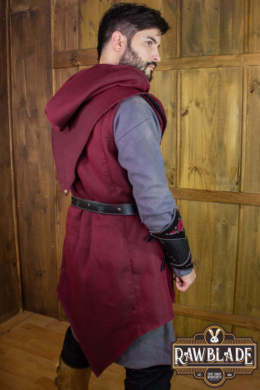 Stylish young man wearing the Karanthir Tunic with a hood, perfect for adventures.