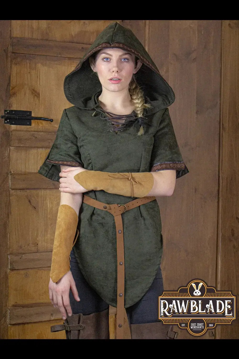 Briannan Ranger Tunic Suede worn by a model, featuring a wide hood and leather trims in an earthy green color.