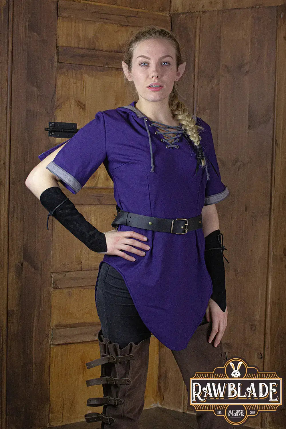 Briannan Ranger Tunic worn by a model, featuring a purple color, wide hood, and stylish leather trims.