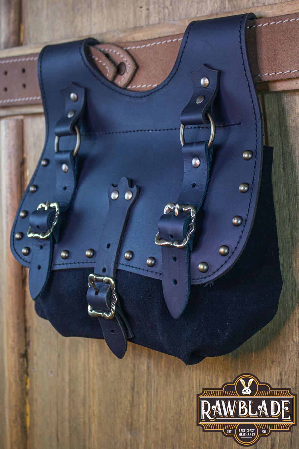 Agor Belt Bag hanging on a leather strap, made of black leather with authentic craftsmanship.