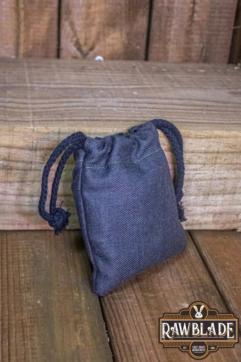 Timber Pouch Premium made of thick cotton with a panama-style fabric in dark color on wooden background.
