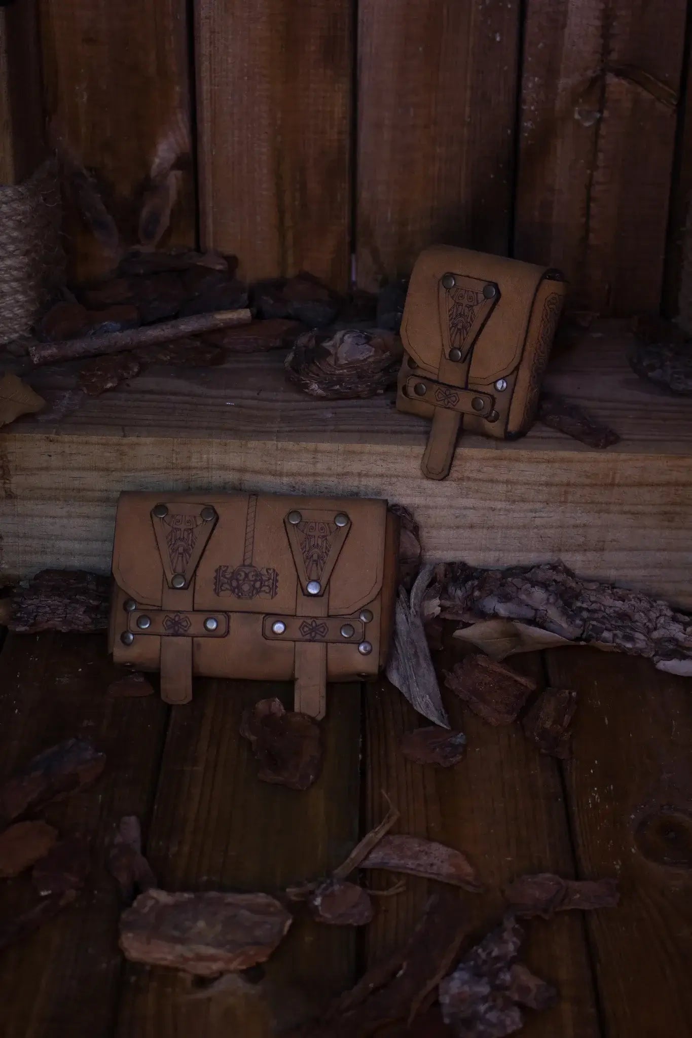 Bormund Pouch Small featured in high-quality leather on a wooden surface with rustic decor.