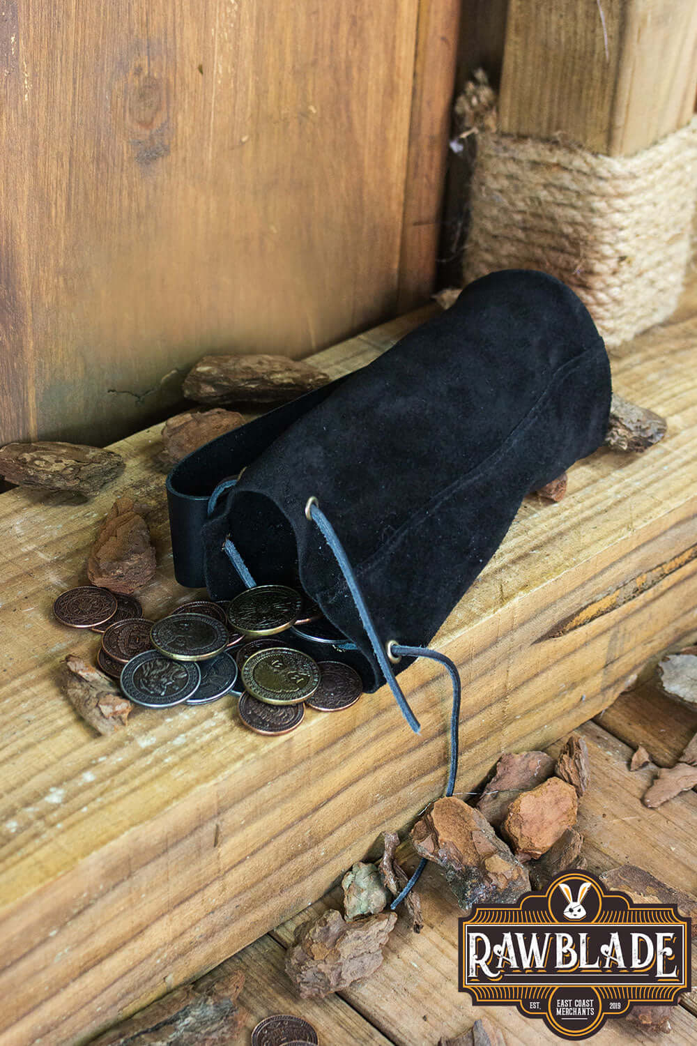 Adventurer Tube Pouch resting on wood, beside scattered coins, perfect for carrying valuables.