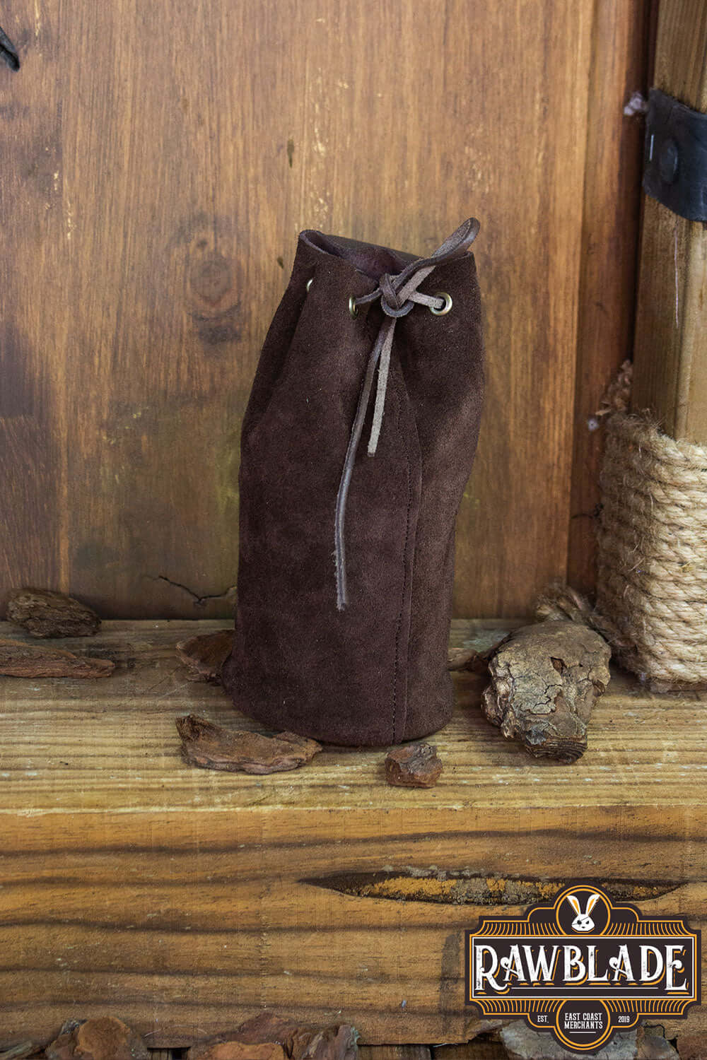 Adventurer Tube Pouch in brown suede, perfect for carrying items like coins, keys, and small bottles up to 33cl.