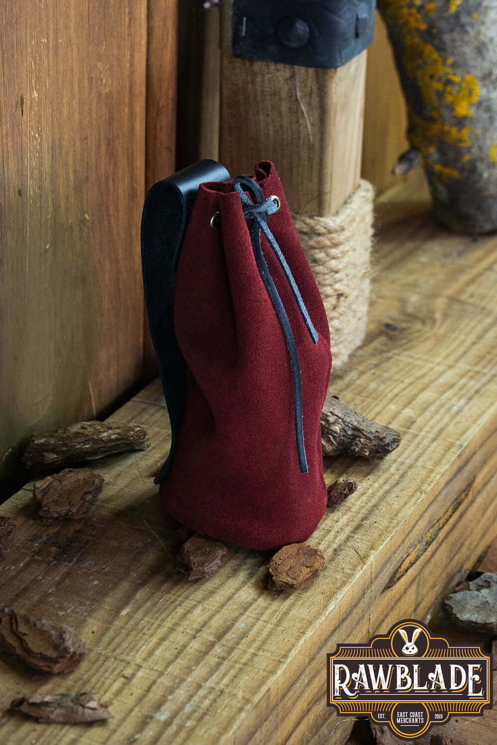 Adventurer Tube Pouch in red suede with drawstring, ideal for carrying coins and small items.