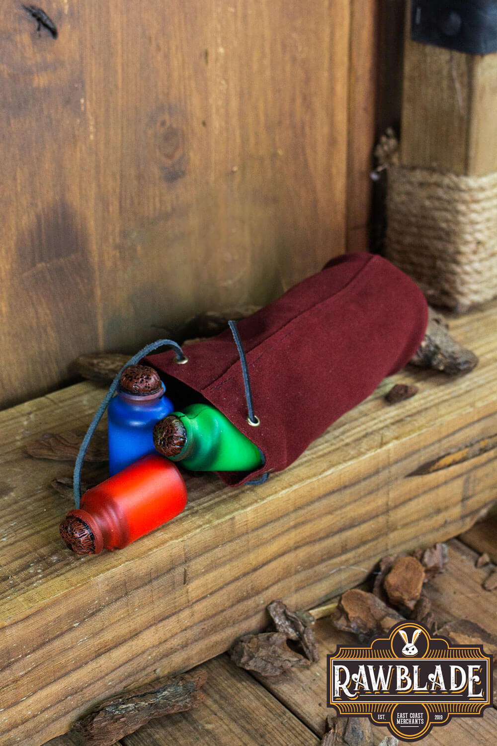 Adventurer Tube Pouch holding colorful items on wooden surface, perfect accessory for adventurers and scholars.