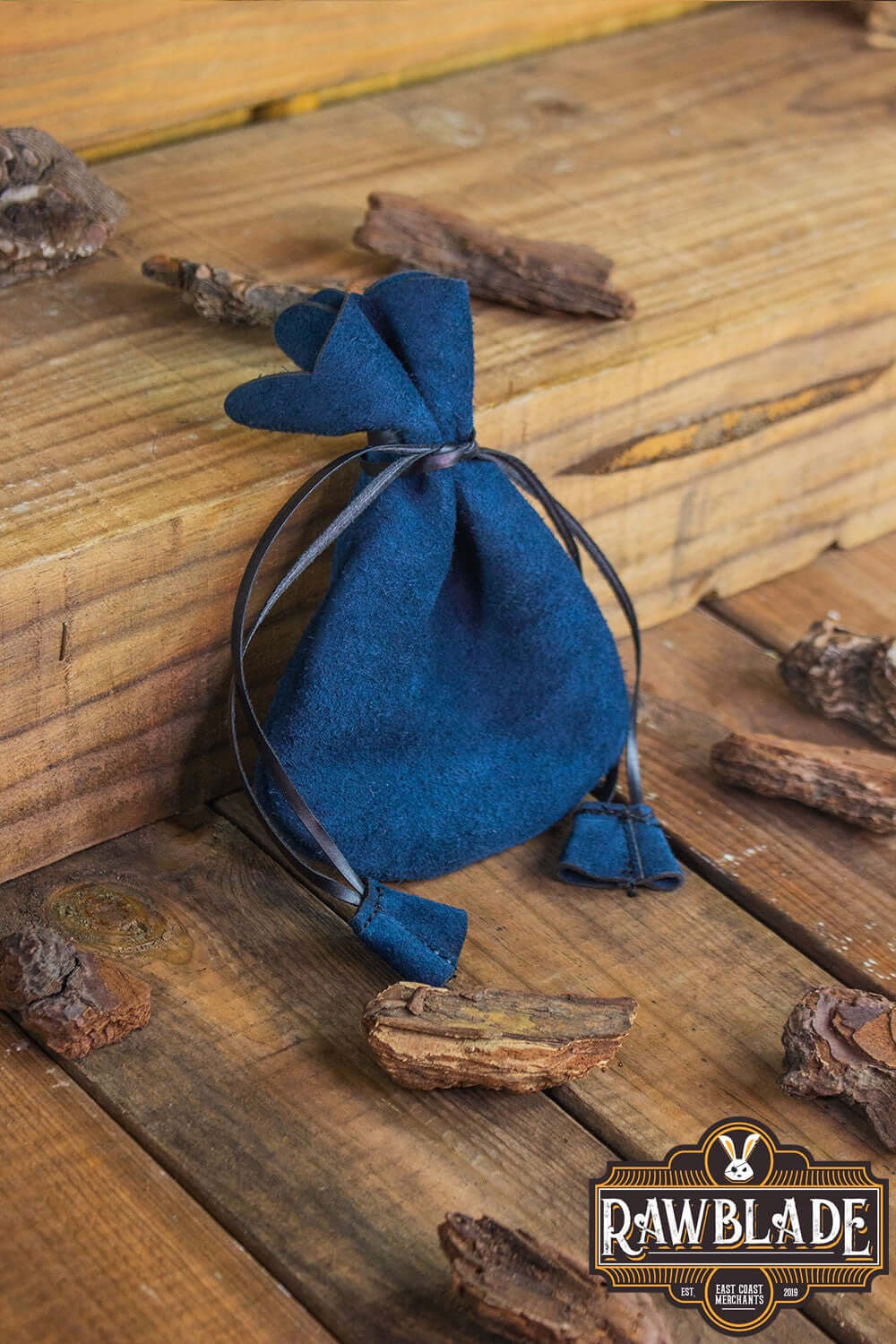 Alentorn Coin Bag made of soft split leather, perfect for keeping valuables safe, on wooden surface.