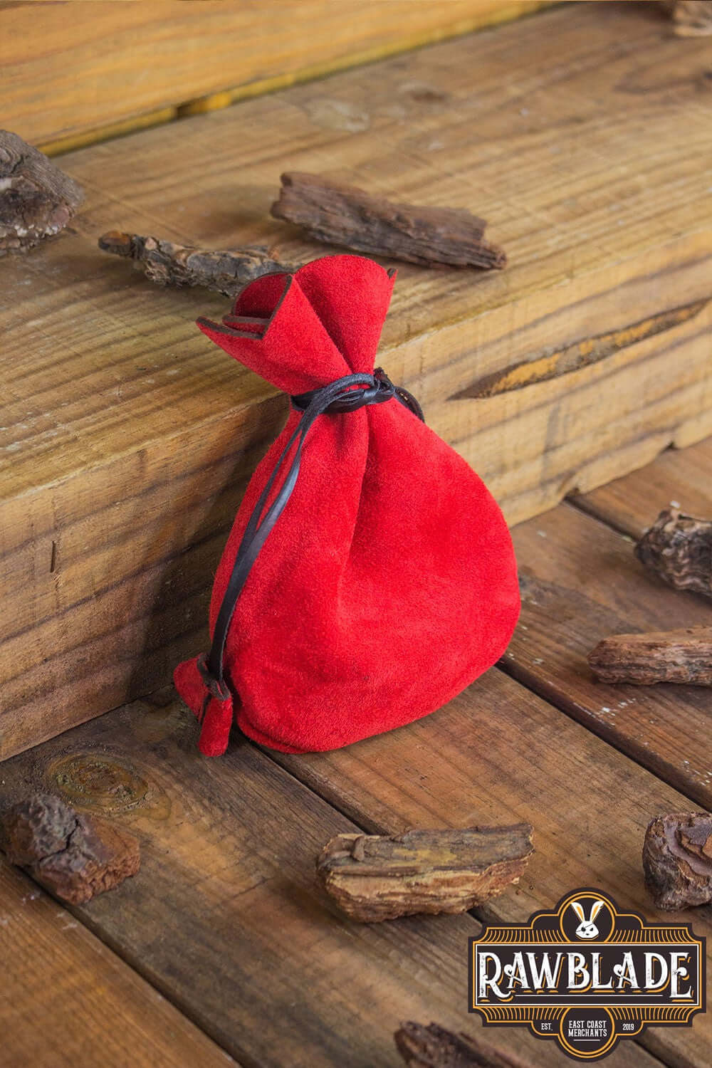 Alentorn Coin Bag in red soft split leather with drawstrings, perfect for storing precious belongings.