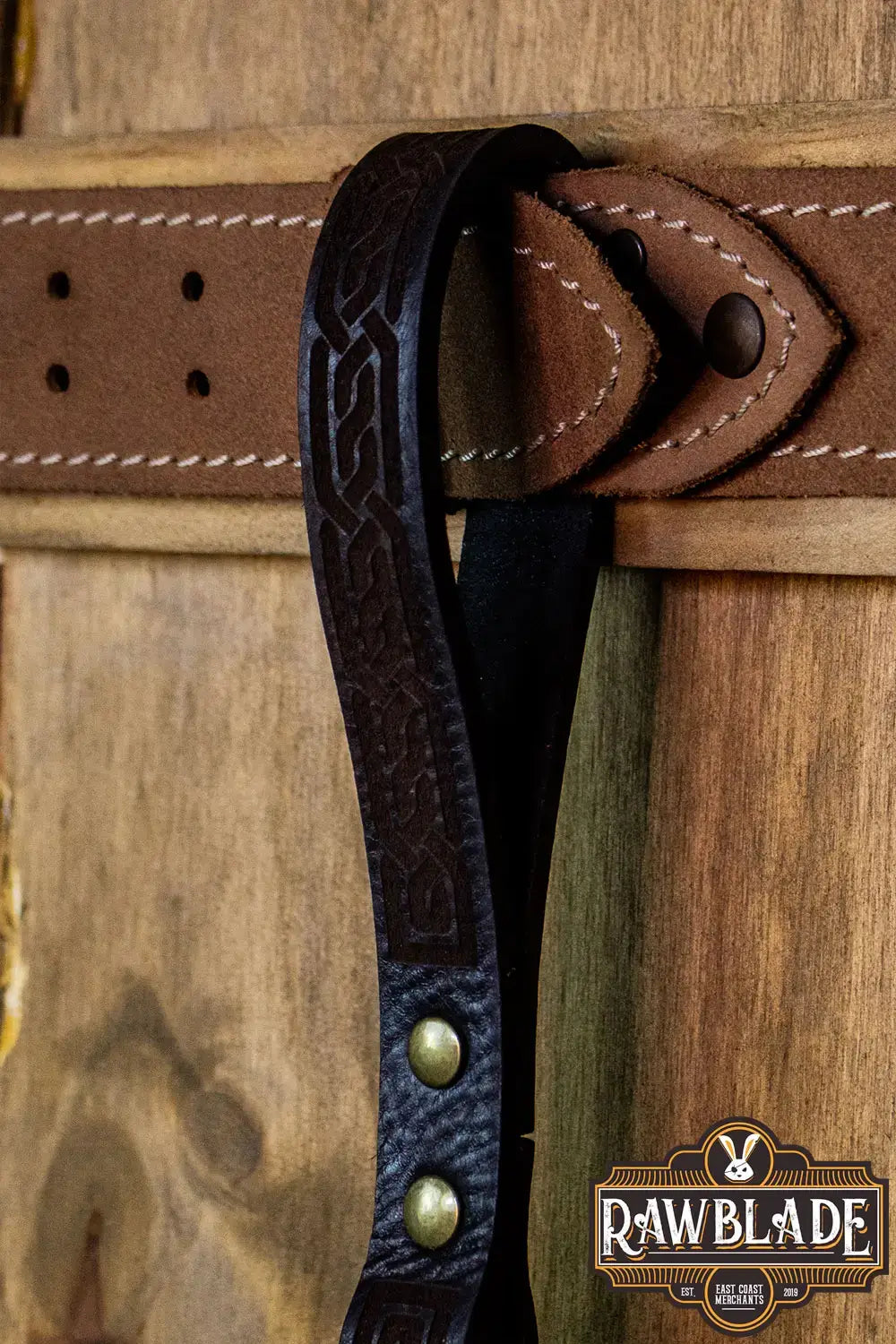 Runar Ring Holder featuring intricate leather engraving and gold rivets, ideal for weapon carry.