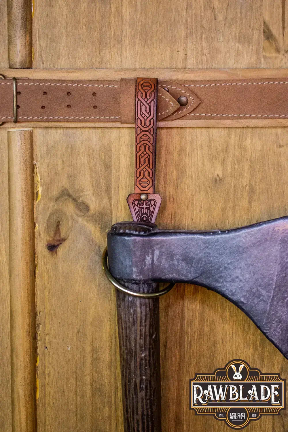 Bormund Ring Holder leather strap detail with ornate engraving on wooden background