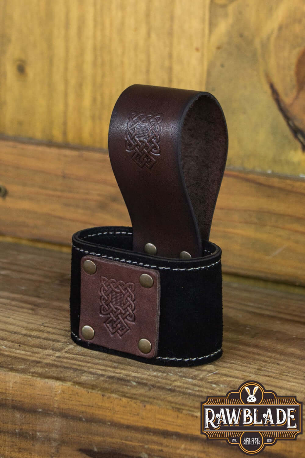 Wanderer Holder made of split leather with Celtic designs, featuring stitched borders and rivets.