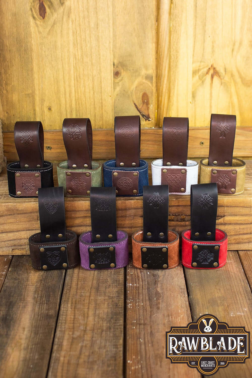 Wanderer Holder collection featuring various colors and designs by Rawblade on a wooden surface.