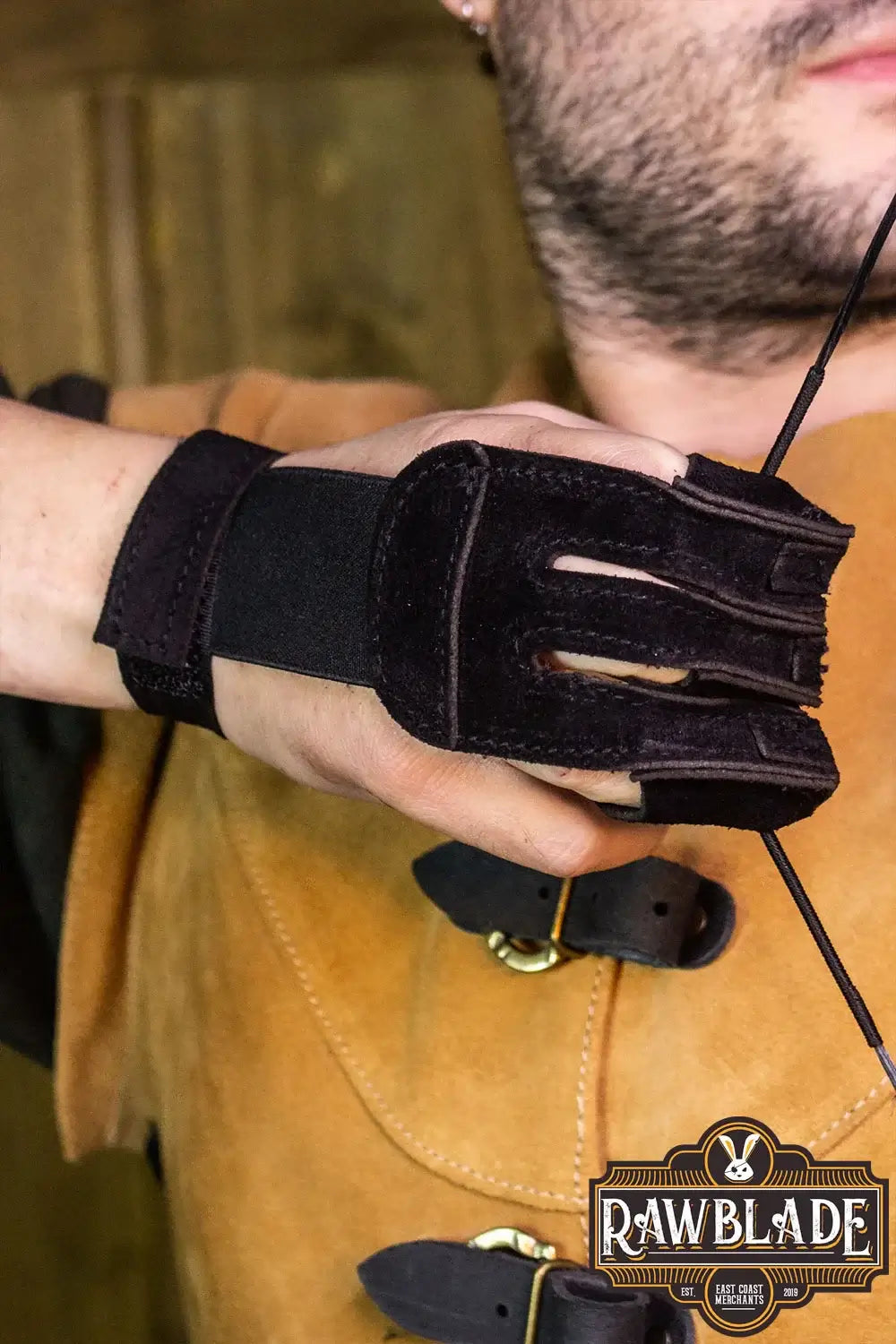 Archery Glove Kane worn on hand, featuring three finger protection, adjustable wrist, and made of high quality split leather.