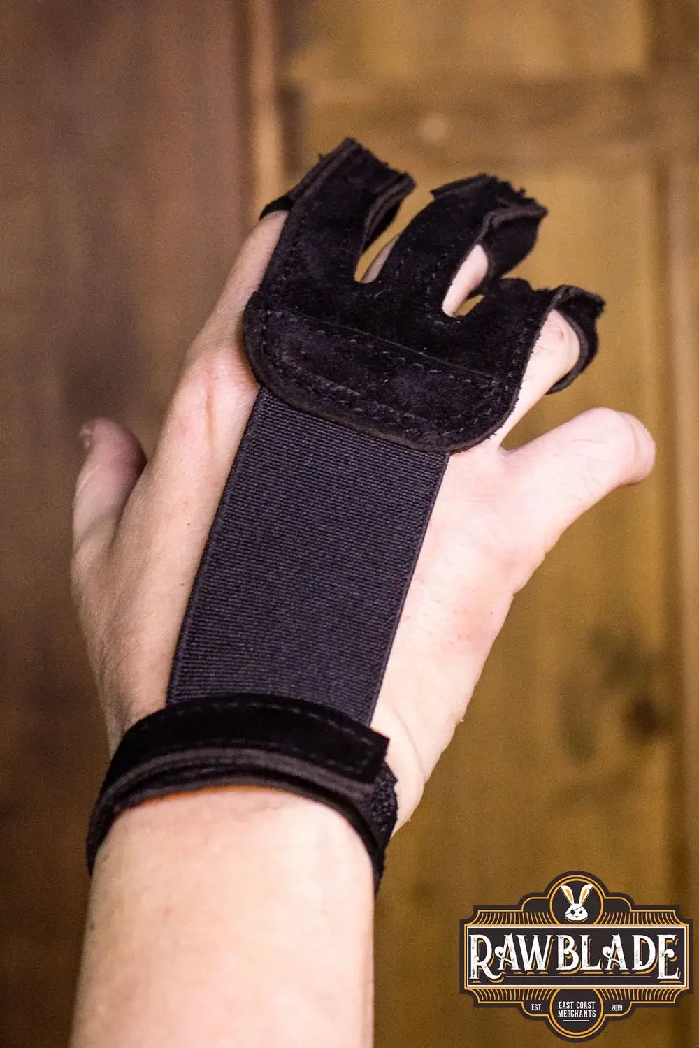 Archery Glove Kane showing a hand wearing a three finger glove with velcro for wrist adjustment.