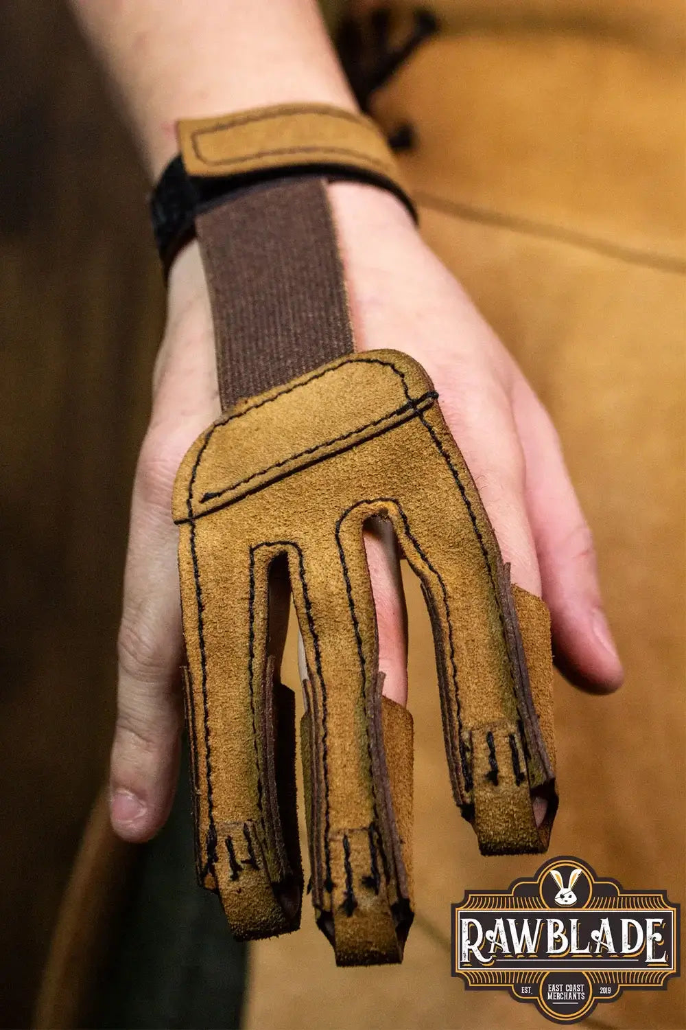 Archery Glove Kane shown on hand, made of split leather, three finger design for optimal protection and comfort.