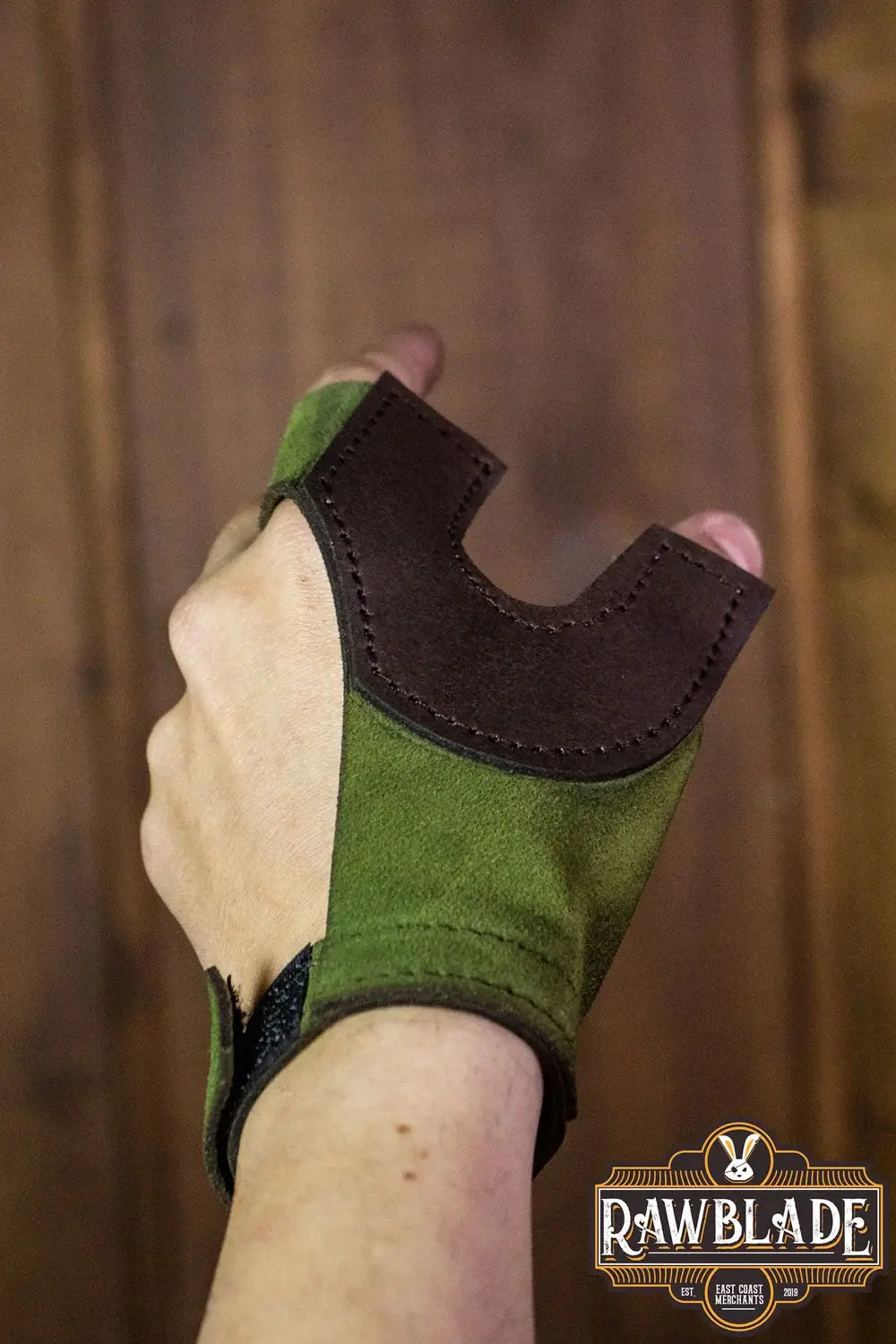 Archery Glove Oren shown in green and brown, designed for bow hand protection with adjustable wrist.