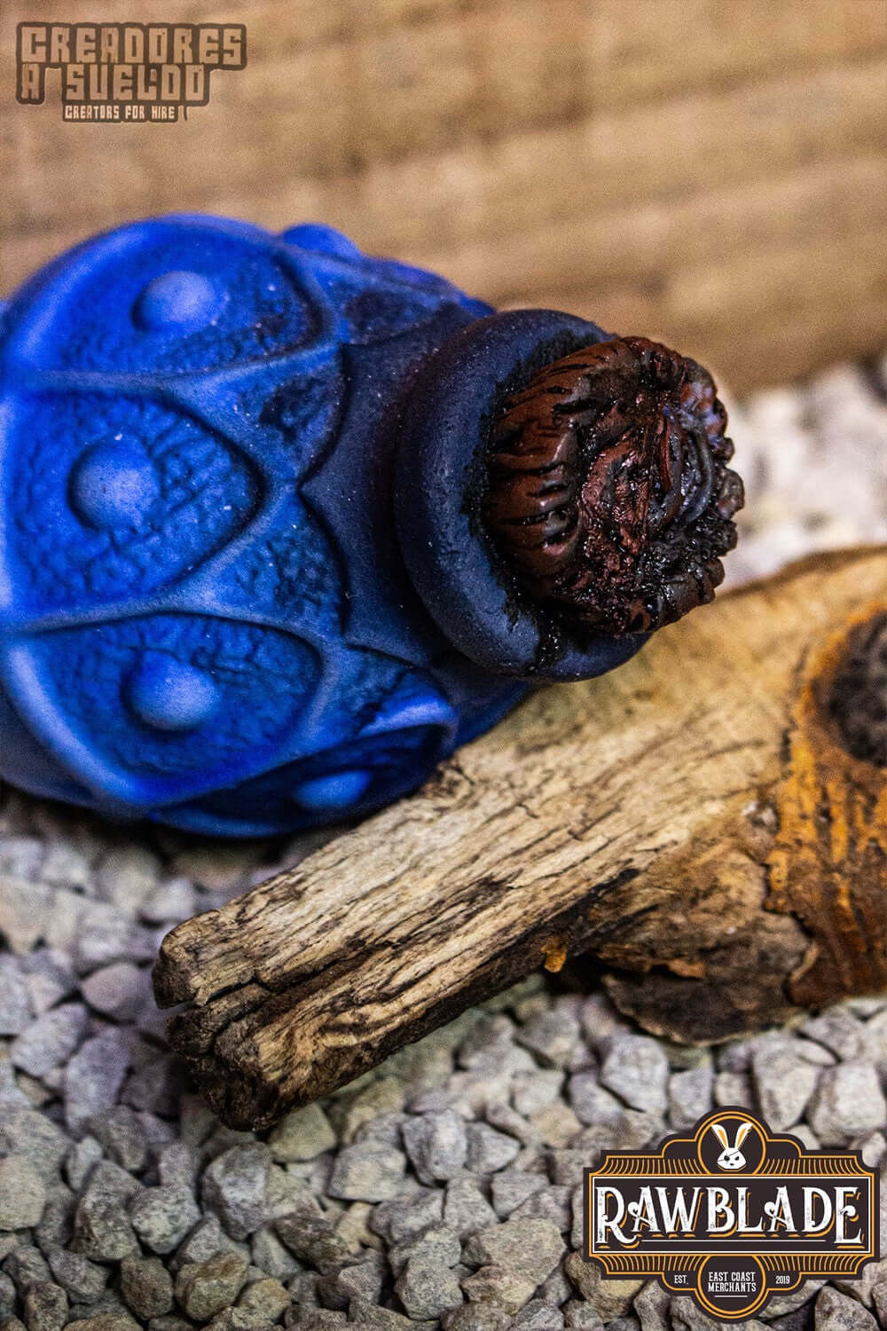 Alchemical Crock in blue color resting on wooden surface, made from flexible polyurethane foam.