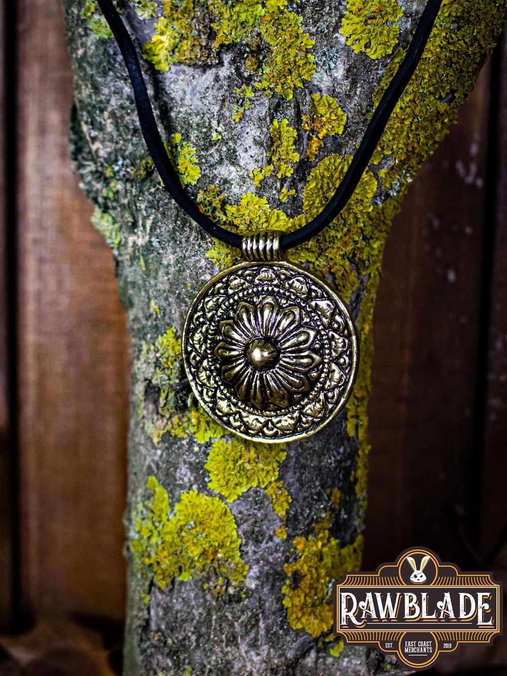 Capadocian Amulet pendant with floral motif and circular design, showcased on a textured wooden background.