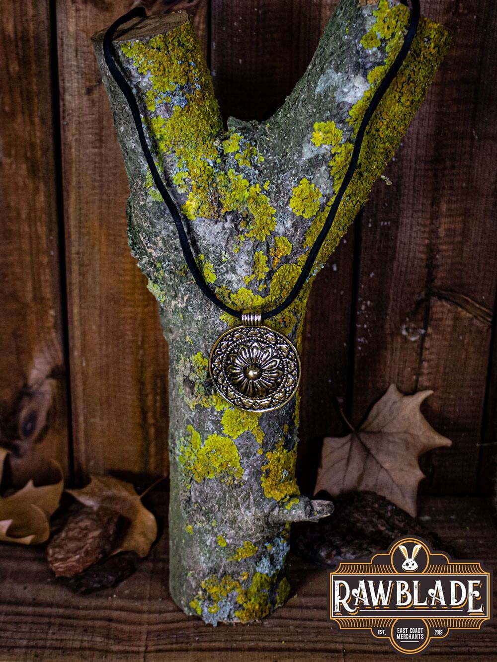 Capadocian Amulet displayed on a textured tree branch with a floral motif and elegant design.