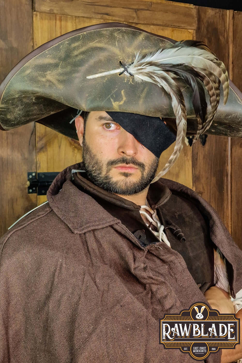 Captain Teague Hat with Feathers worn by a model, featuring a weathered look and decorative feathers.