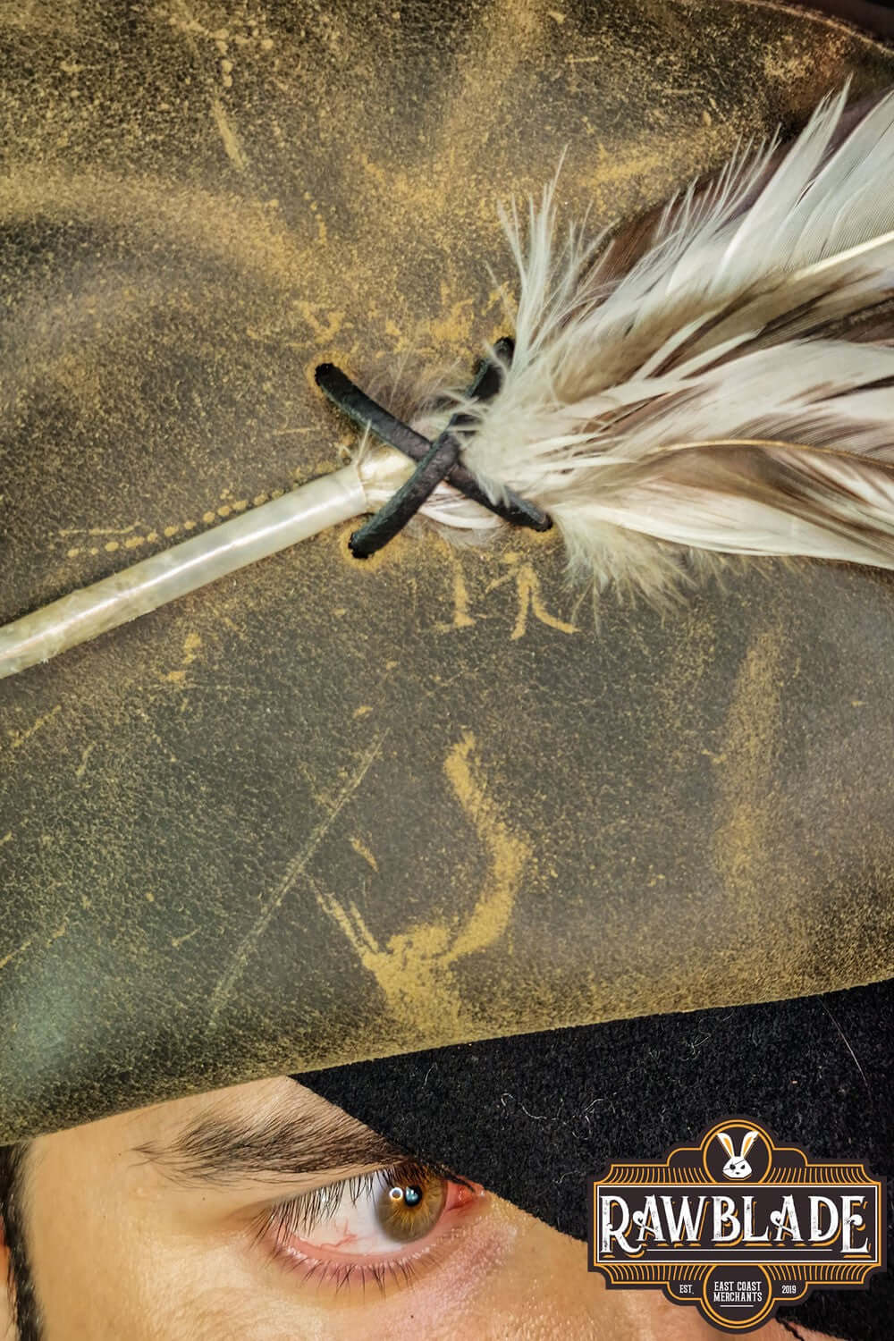 Close-up of the Captain Teague Hat with Feathers featuring a feather accent and weathered texture.