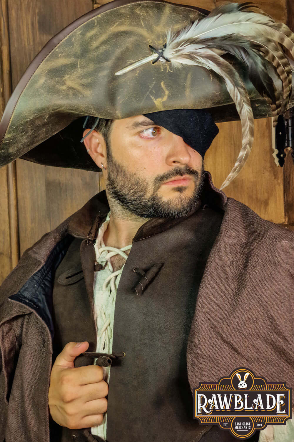 Captain Teague Hat with Feathers worn by a man, featuring a weathered look and decorative feathers.