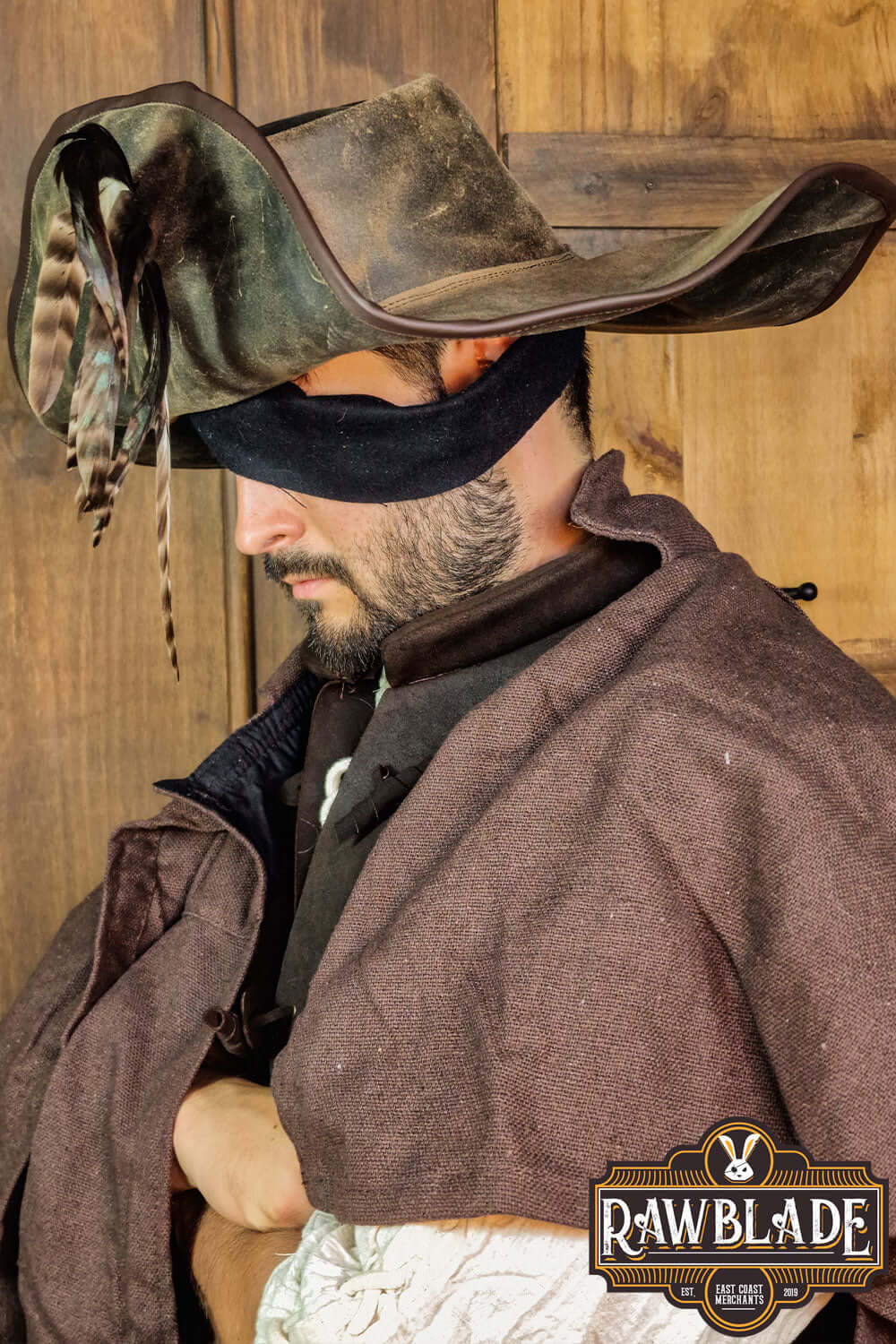 Captain Teague Hat with Feathers worn by a man, showcasing its weathered look and authentic pirate style.