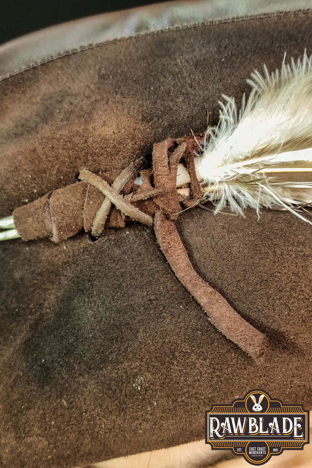 Close-up view of the Captain Teague Hat with Feathers showing the detailed feather and leather accents.